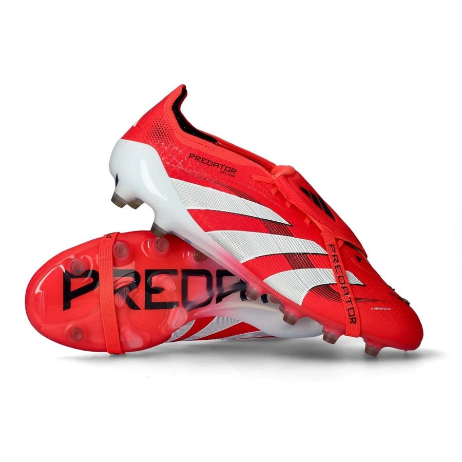Pair of Adidas Predator Elite firm-ground football boots in red and white, one resting on its studded sole.